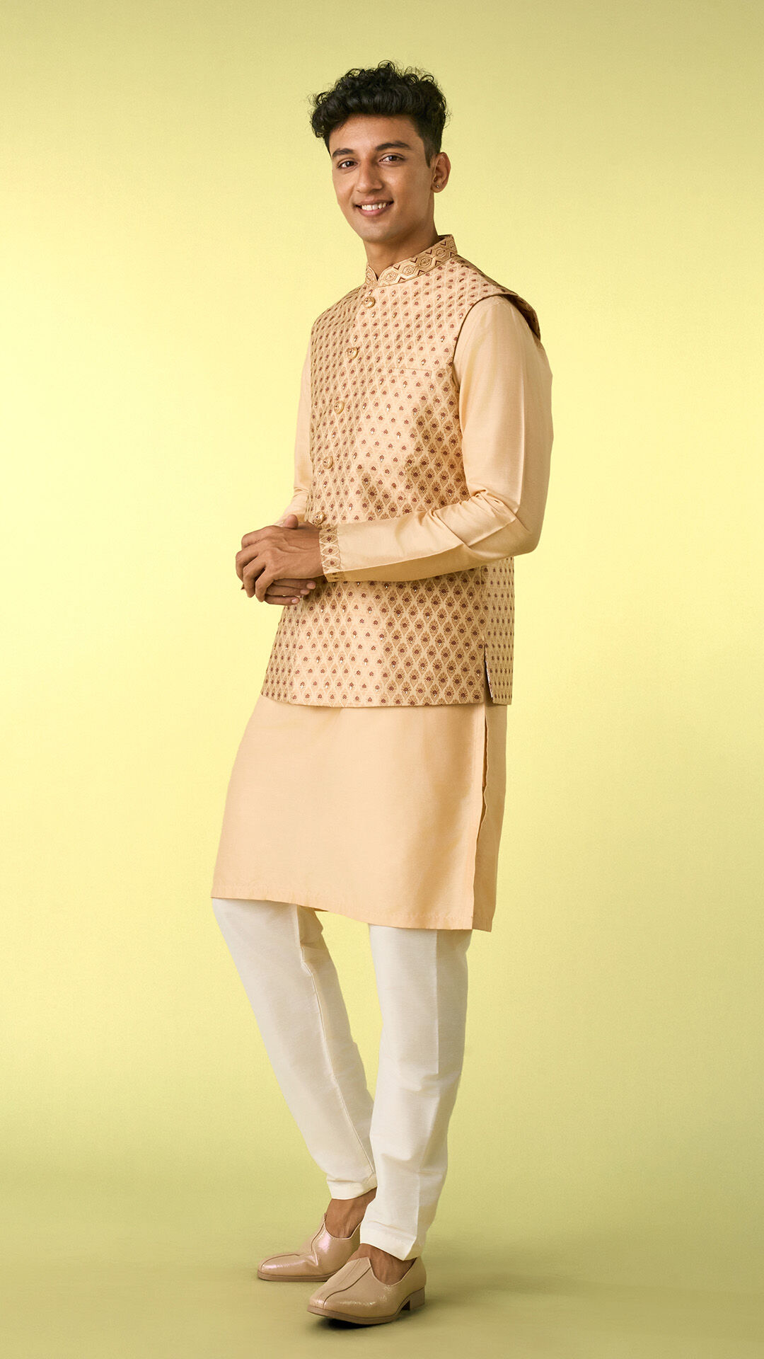 Man in an ivory traditional outfit, presenting a refined blend of comfort and elegance for special occasions.